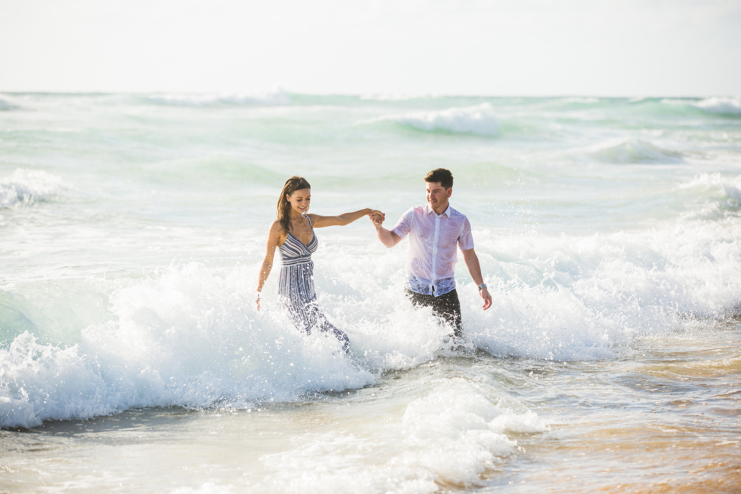 fun engagement photo shoot on surf beach